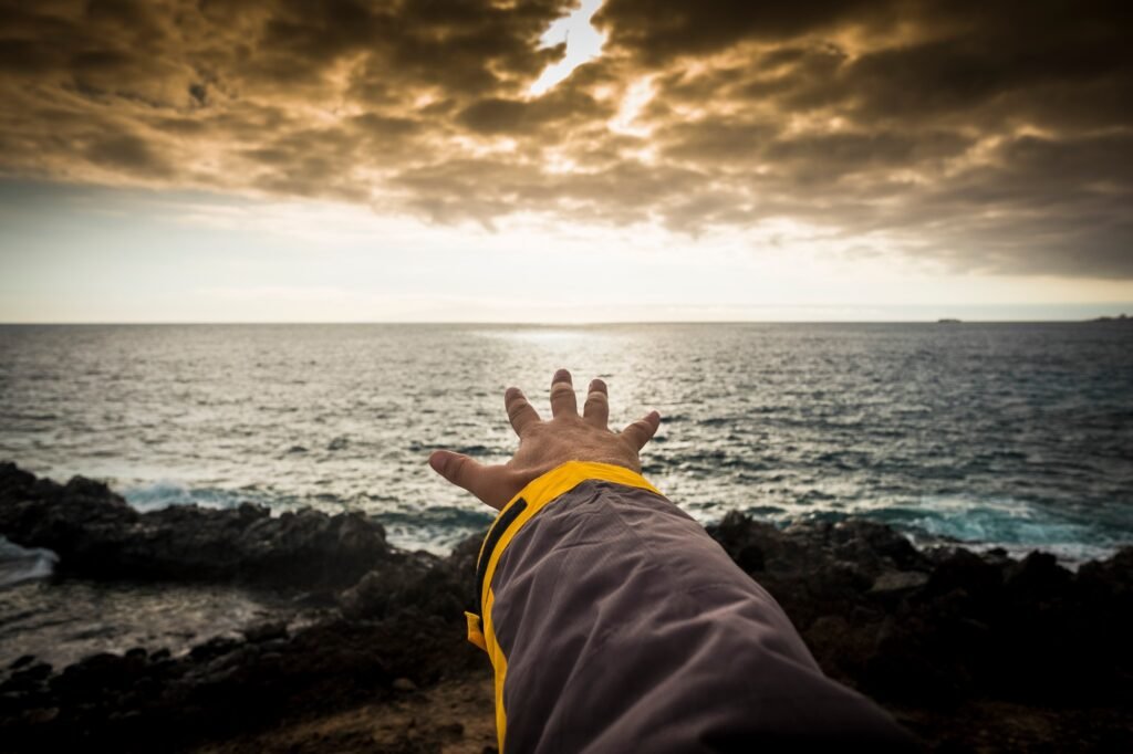 adventure concept for man hand like to touch the horizon. free travel spirit